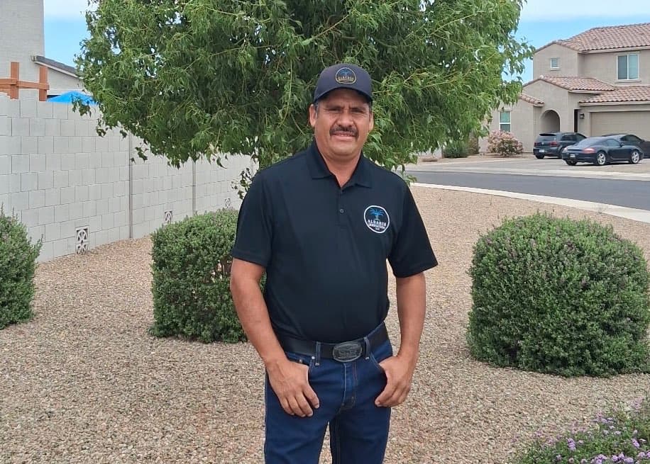 Albares Irrigation team member in a landscaped residential yard